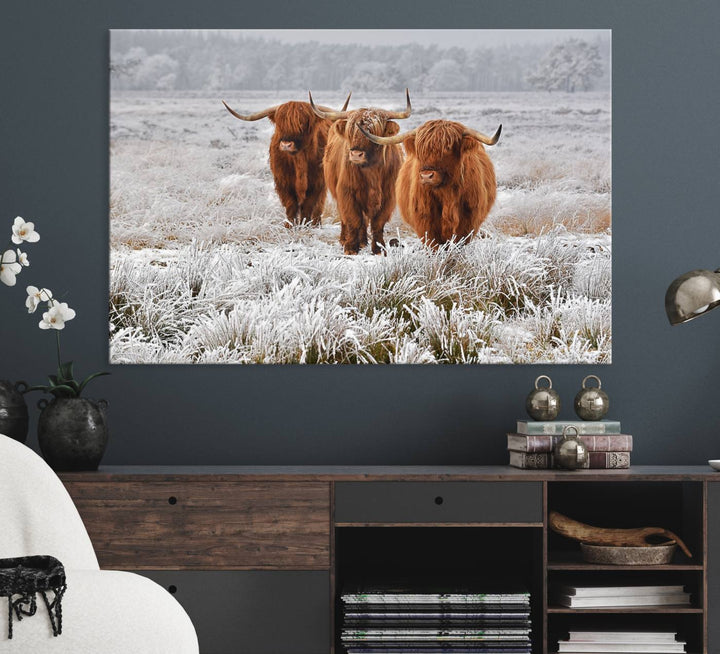 The Highland Cows in Snow canvas showcases three cattle in a frosty field.