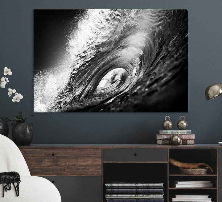 The Black Ocean Wave at Sunset Canvas Art hangs on a grey wooden wall.