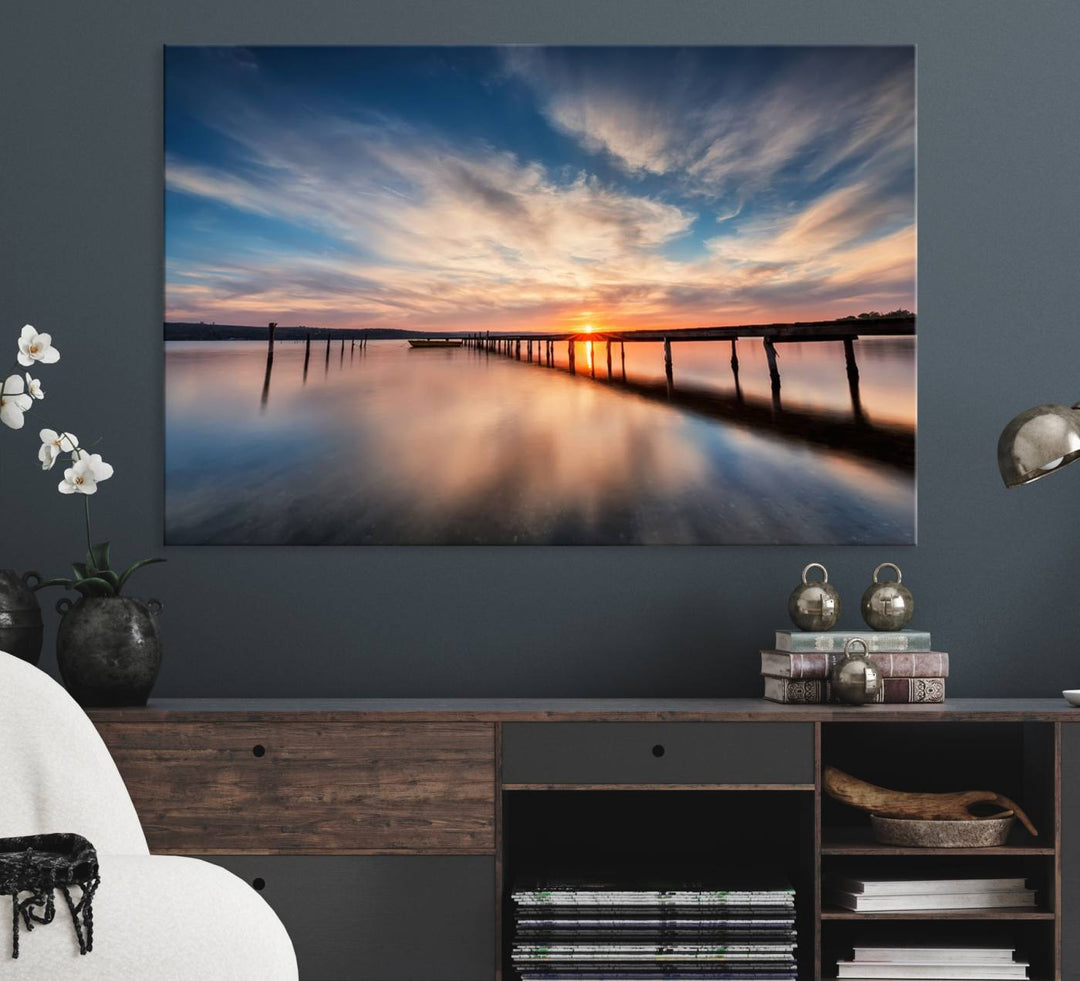 The Sunset Pier Canvas features a serene coastal landscape with vibrant hues under cloudy skies, ideal for modern decor.