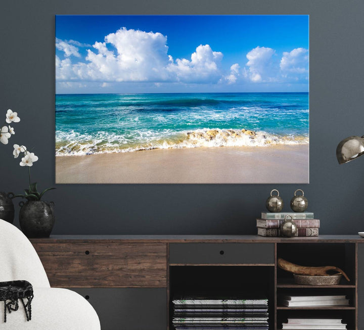 The Tropical Beach 3-Panel Canvas Wall Art features ocean waves gently lapping on a beach under blue skies, making it an ideal choice for coastal decor.