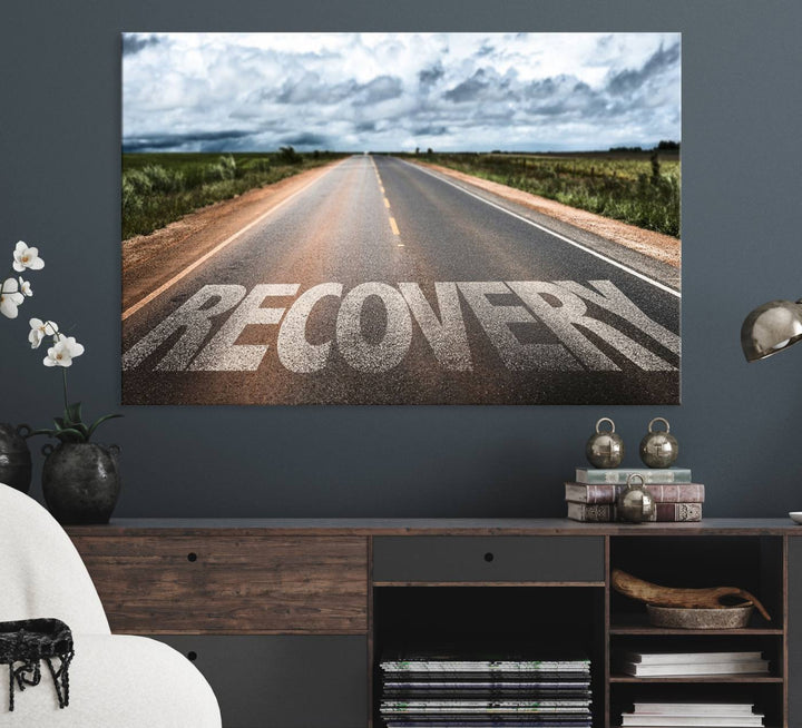 The Recovery Road Wall Art Canvas Print depicts a road under a cloudy horizon.