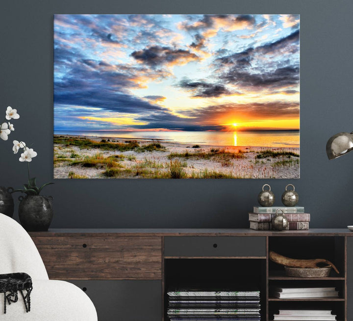 The Sunset On The Ocean canvas wall art features a beautiful beach sunset with grass and clouds.