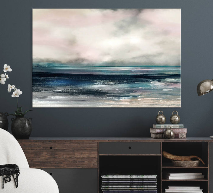 A contemporary abstract wall art canvas print in pastel pink, teal, and gray tones hangs on the wall.