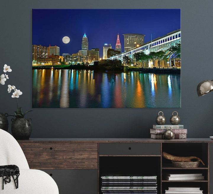 Cleveland City Lights Night Skyline Wall Art canvas showcases a moonlit cityscape reflected on water.