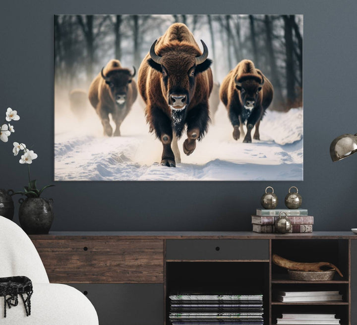 Wall art titled Cow Bighorn shows three bison running through snow in a forest.