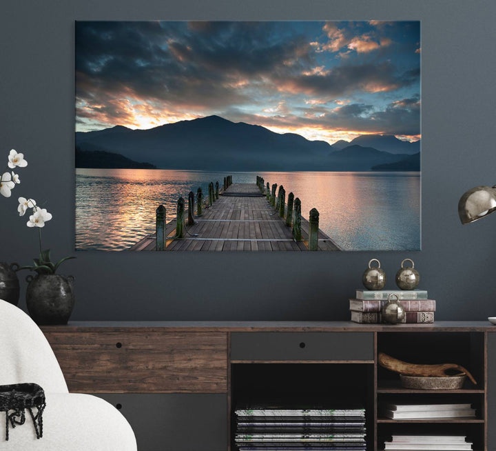 The Mountain Lake Wood Pier Canvas Wall Art depicts a serene lake and mountains, enhancing the beauty of any space.