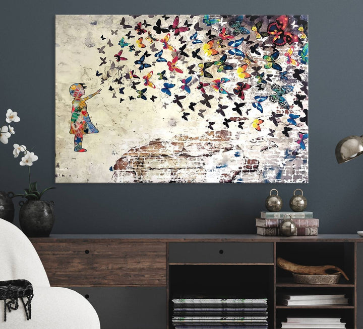 A Banksy Girl Butterfly Canvas Print is displayed on the textured wall.