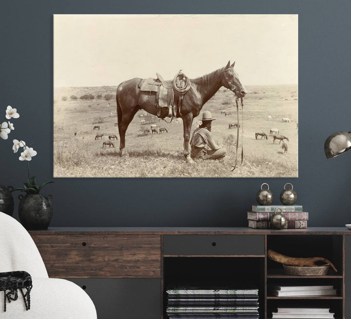 Cowboy Wall Art - Vintage Western Horse Canvas Print features a cowboy kneeling by his horse in a field.