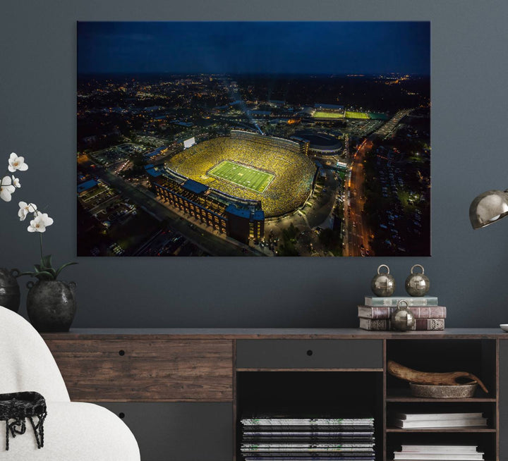 Aerial view of Michigan Stadium at night, surrounded by city lights, depicted on a Michigan Wolverines wall art canvas print.