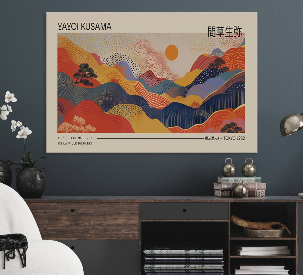 The Yayoi Kusama vibrant landscape canvas print featuring abstract mountains and a sun enhances the space with its modern aesthetic.