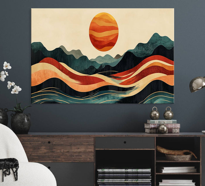 The Mountain Triptych wall art, featuring a design of the sun, mountains, and waves, is displayed prominently on the wall.