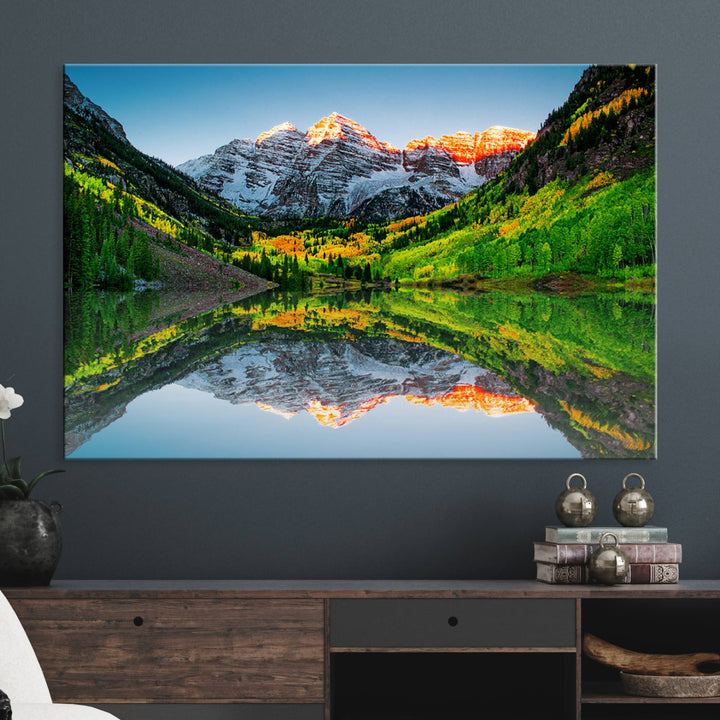 The Sunrise Maroon Bells Lake Wall Art Print beautifully captures North Maroon Peak mirrored in the tranquil lake, framed by lush greenery.