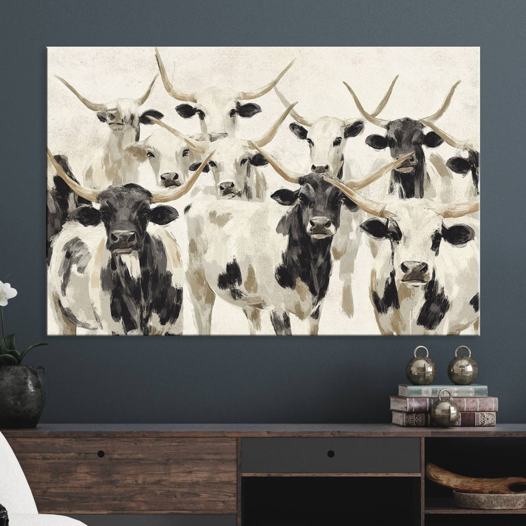 Canvas print titled Longhorn Texas Cow Drawing, depicting longhorn cattle with black and white markings, made in the USA, displayed on the wall.