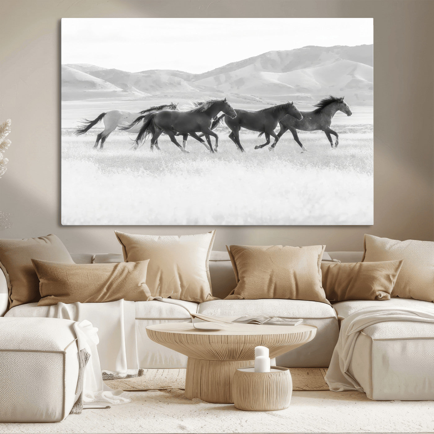 A black and white image of wild horses running freely across an open grassland, capturing the power and beauty of untamed nature in a rustic western setting.