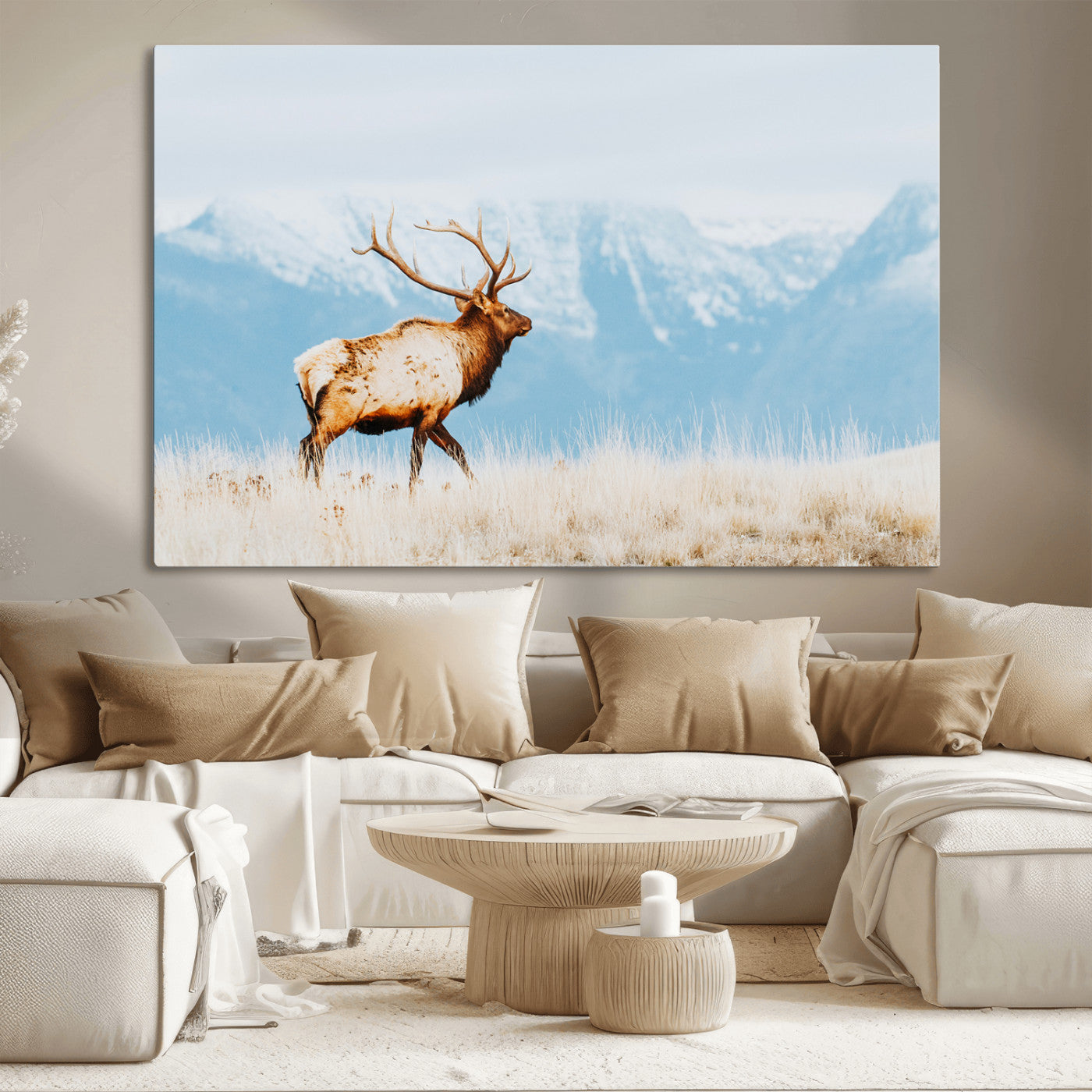 Majestic elk standing on dry grassland with snowy mountains in the background, ideal for rustic or lodge-inspired wall decor.
