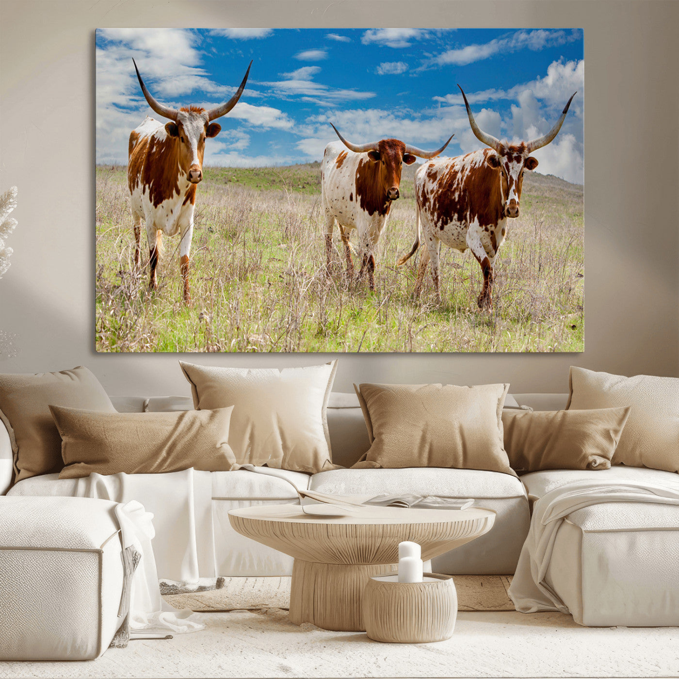 Three Texas longhorn cattle standing in dry grass under a bright blue sky, ideal for farmhouse or western rustic home decor.