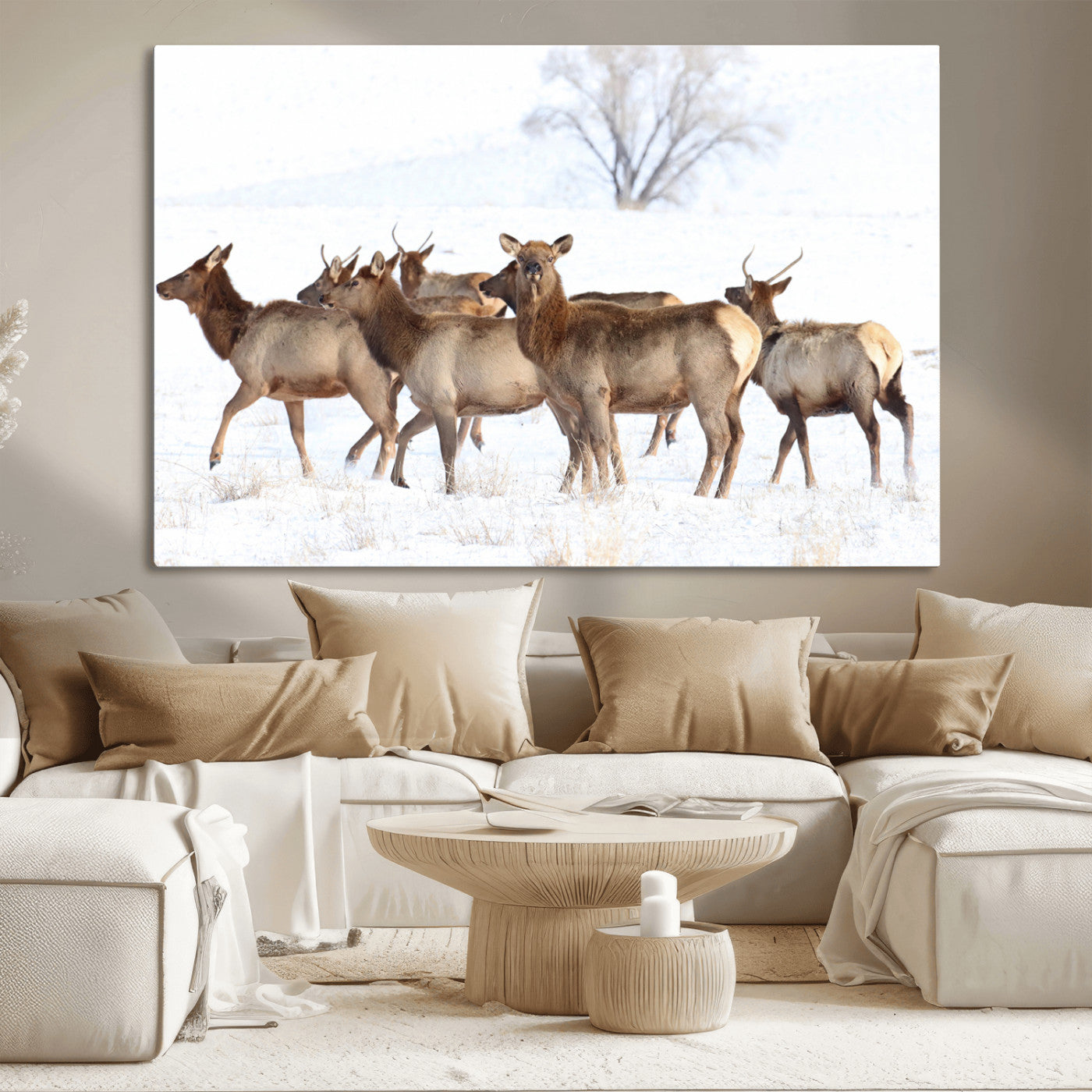 A group of elk standing on snowy terrain with a tree in the background, perfect for rustic or lodge-style winter wall decor.