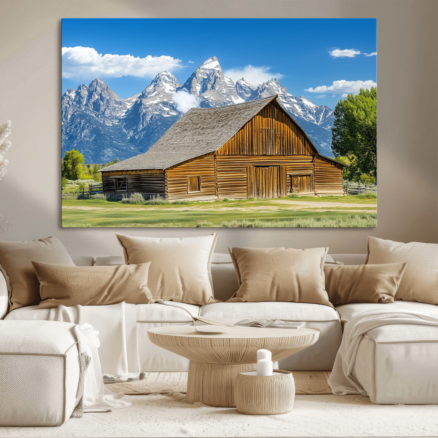 A rustic wooden barn sits in front of towering mountain peaks under a clear blue sky, perfect for farmhouse or cabin style interiors.