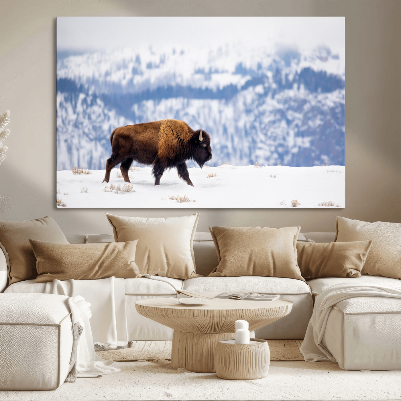A lone bison walks across snowy ground with blue-toned mountain range behind, ideal for rustic or western farmhouse interiors.