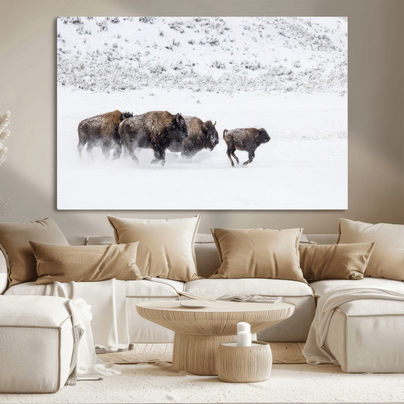 Bison herd running through a snowy open field with mountain backdrop, perfect for rustic or western-themed wall decoration.
