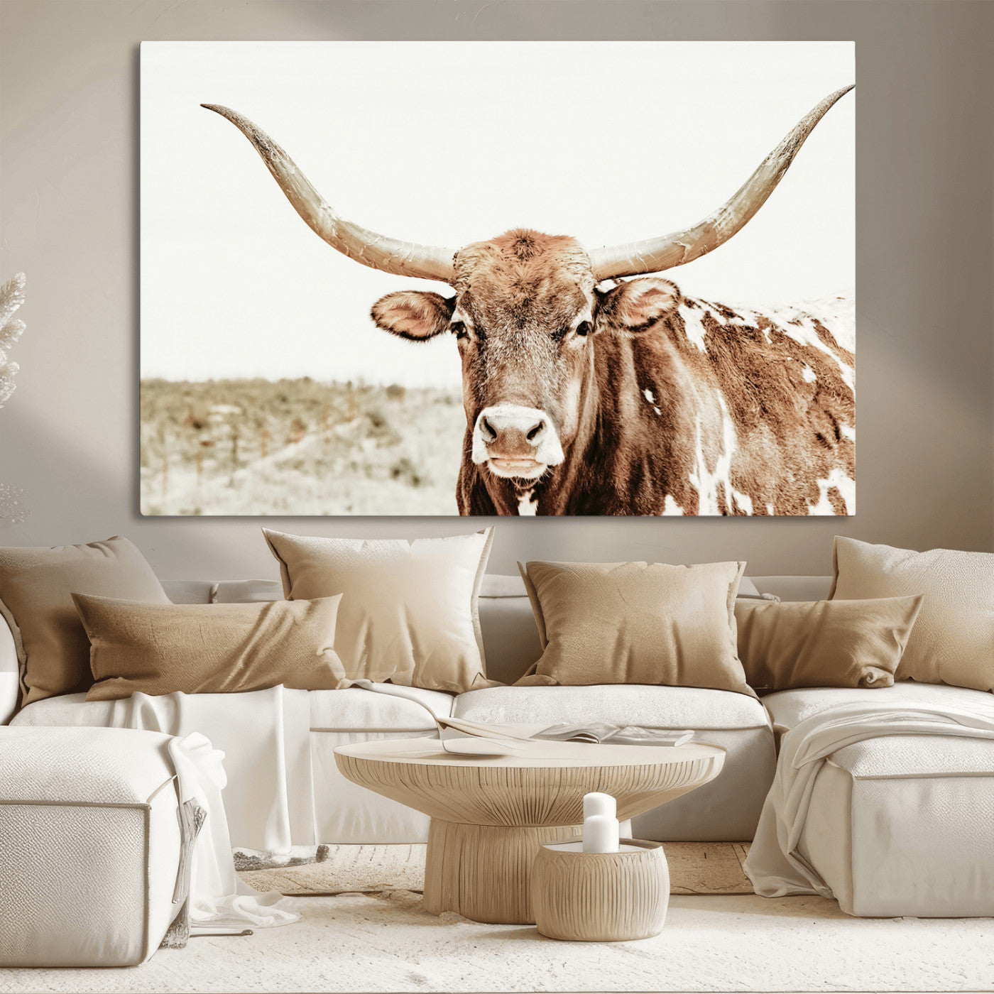 A Texas longhorn bull with wide horns, standing in a dry field under soft light, ideal for rustic farmhouse or western-themed interiors.