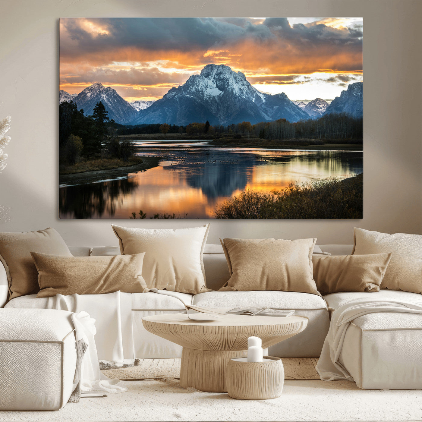 Snow-capped mountains reflecting in a calm lake at sunset, with a dramatic golden sky creating a breathtaking wilderness scene.