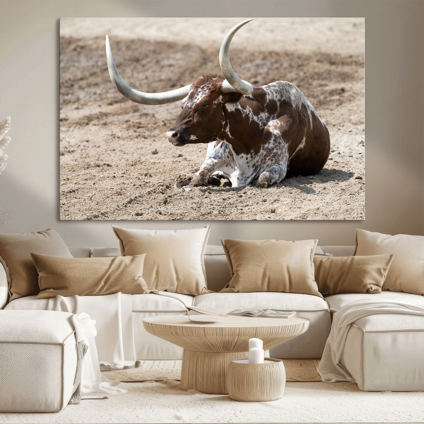 Texas Longhorn resting on sandy ground with large curved horns, capturing a rustic Western aesthetic perfect for farmhouse-style wall art.