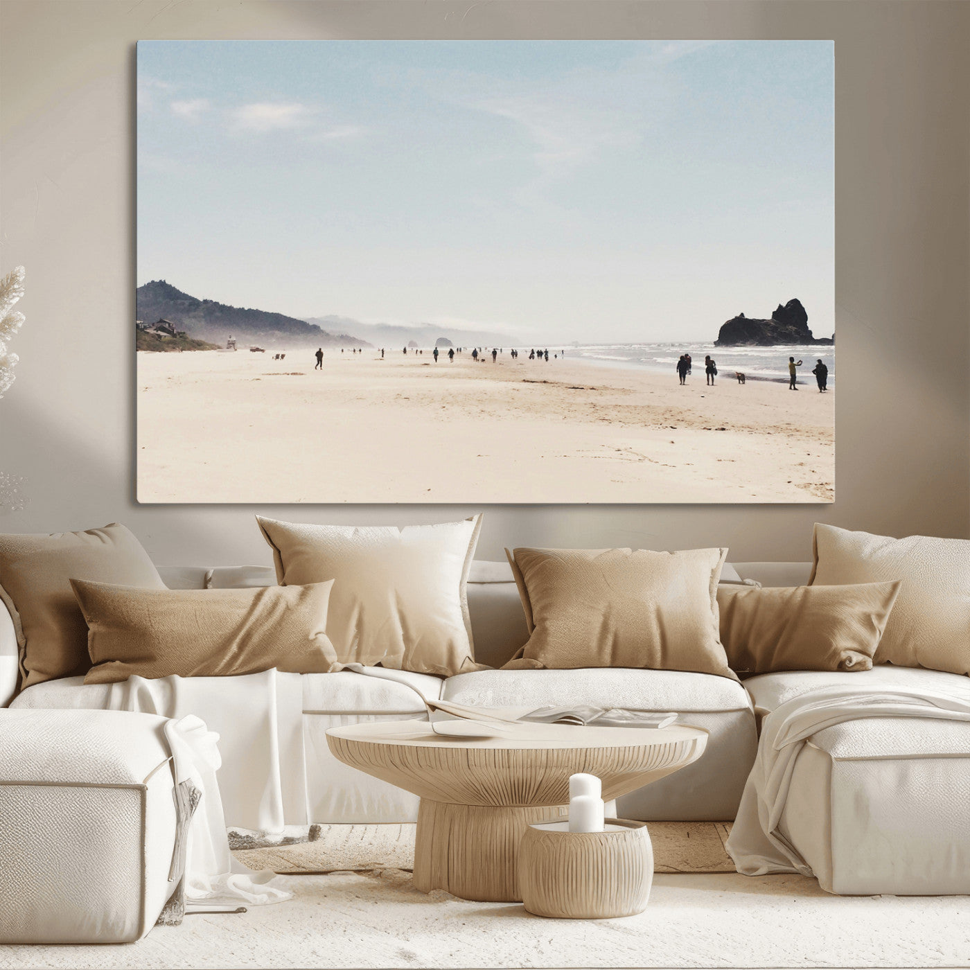 A serene beach with soft sand, misty mountains, and scattered people walking along the shoreline, creating a peaceful coastal landscape.