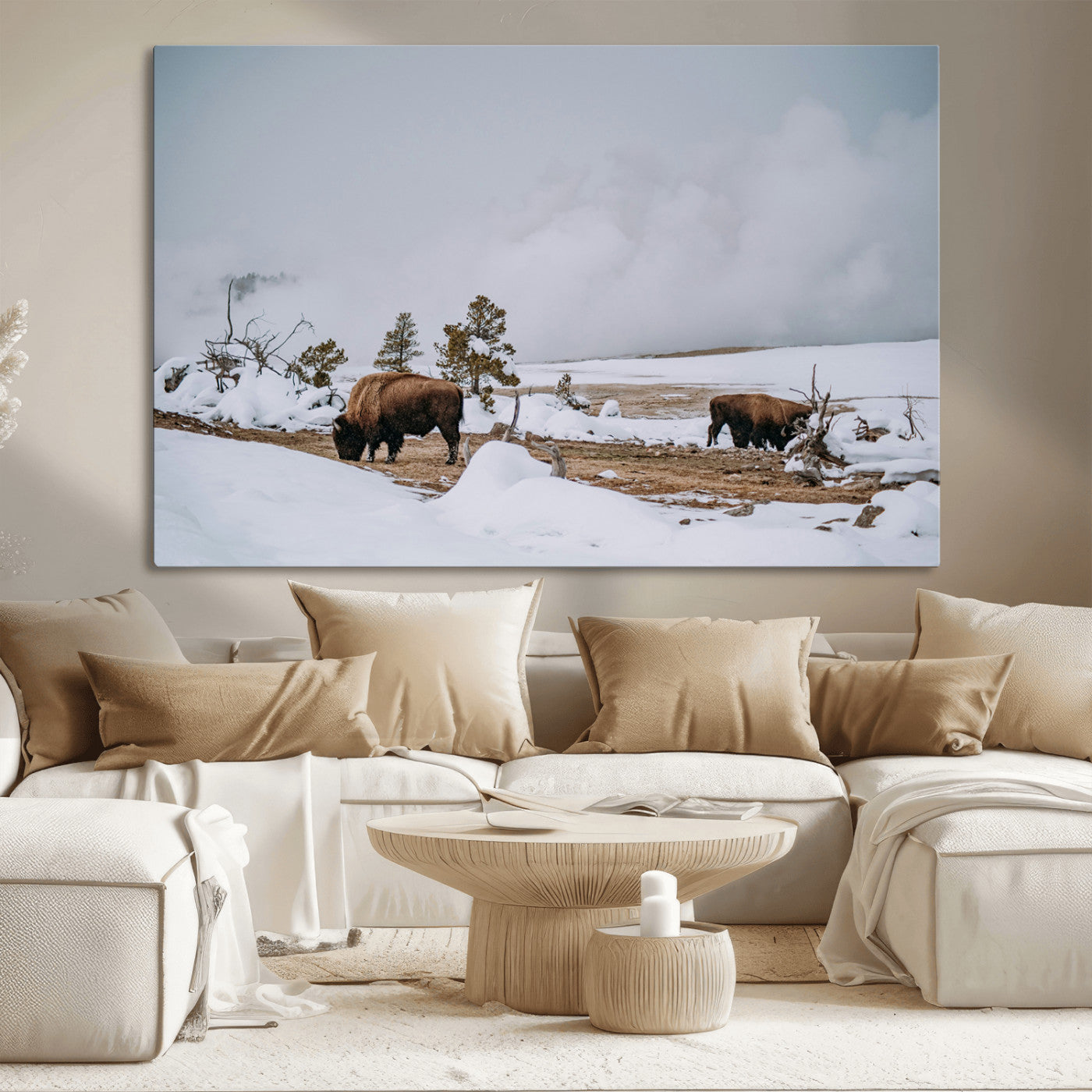 Two bison grazing in a snowy open landscape with misty hills in the background, creating a peaceful and rustic winter scene.