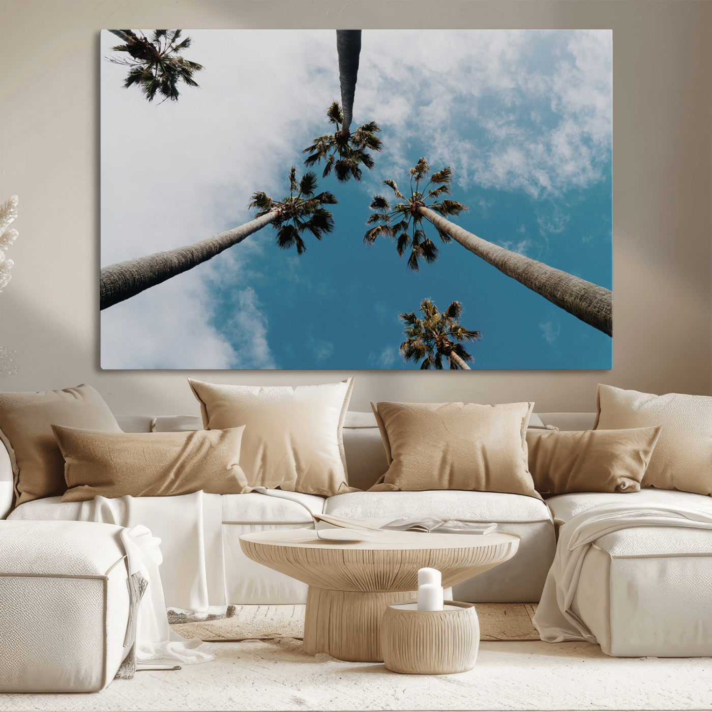Looking up at tall palm trees against a bright blue sky with scattered clouds, creating a tropical and airy atmosphere for modern home decor.