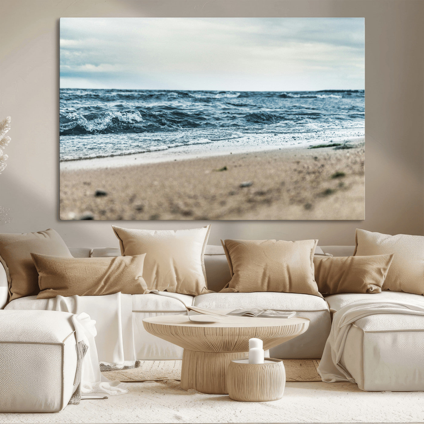 A moody ocean scene with gentle waves washing onto a sandy beach under a cloudy sky, creating a peaceful and coastal atmosphere.