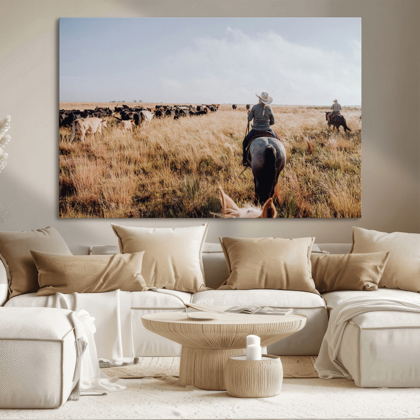 A cowboy and cowgirl on horseback herding cattle through golden grasslands, capturing a rustic and authentic Western ranch lifestyle.