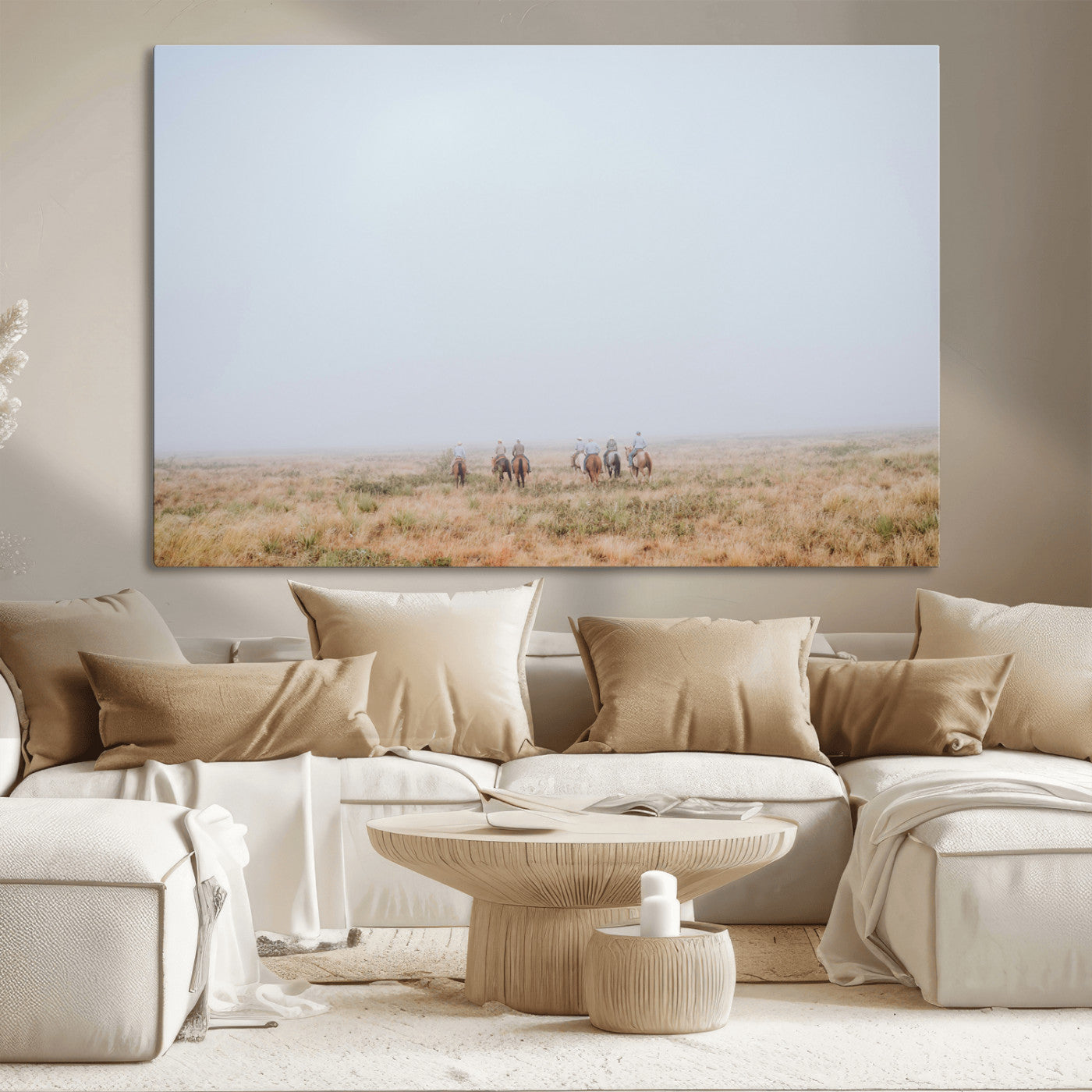 A group of horseback riders moving through a fog-shrouded field, evoking a calm Western scene with golden grasses and soft horizons.