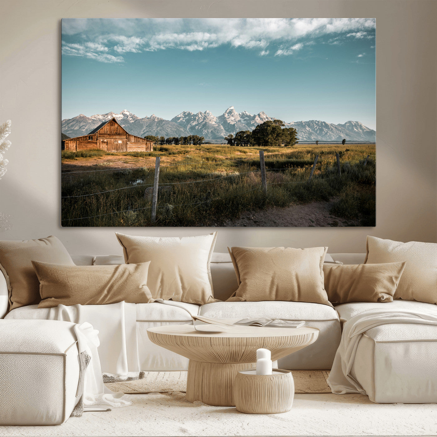 A rustic farmhouse with a wooden barn set against majestic mountain peaks under a soft blue sky, evoking peaceful countryside charm.