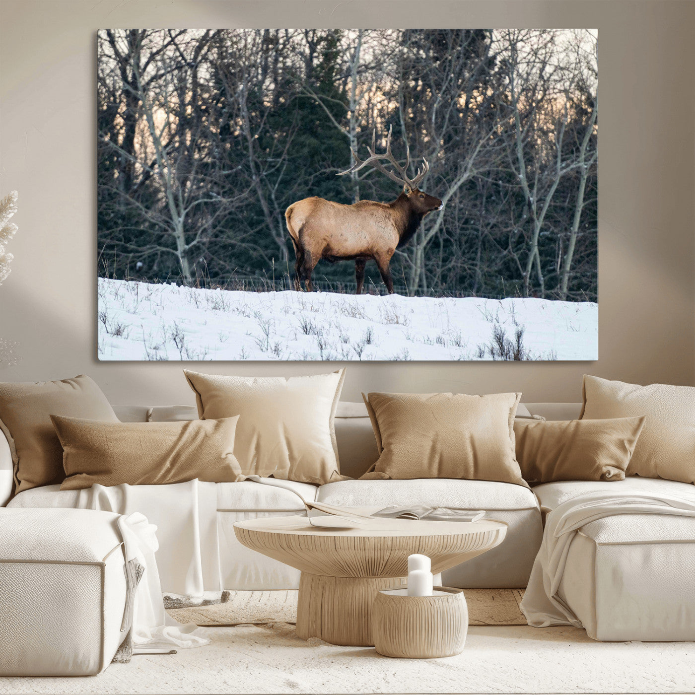 A majestic elk with large antlers standing in a snowy field against a winter forest backdrop, perfect for rustic and wildlife-themed home decor.