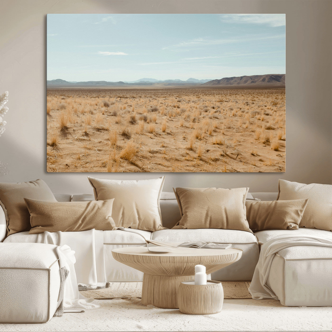Expansive desert landscape with scattered dry grass and distant mountain range under a pale blue sky – Wall Art Canvas Print.
