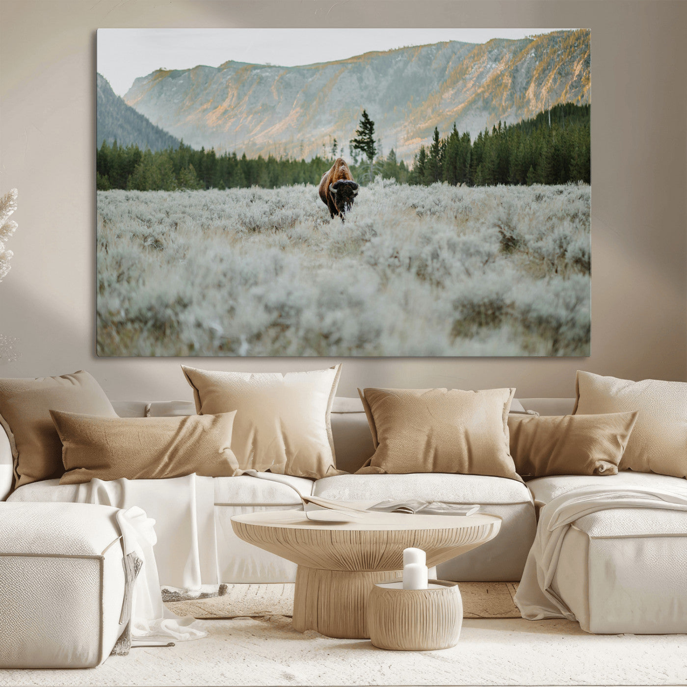 Lone bison standing in a frosted sagebrush field with a pine forest and rugged mountain range in the background under soft morning light – Wall Art Canvas Print.