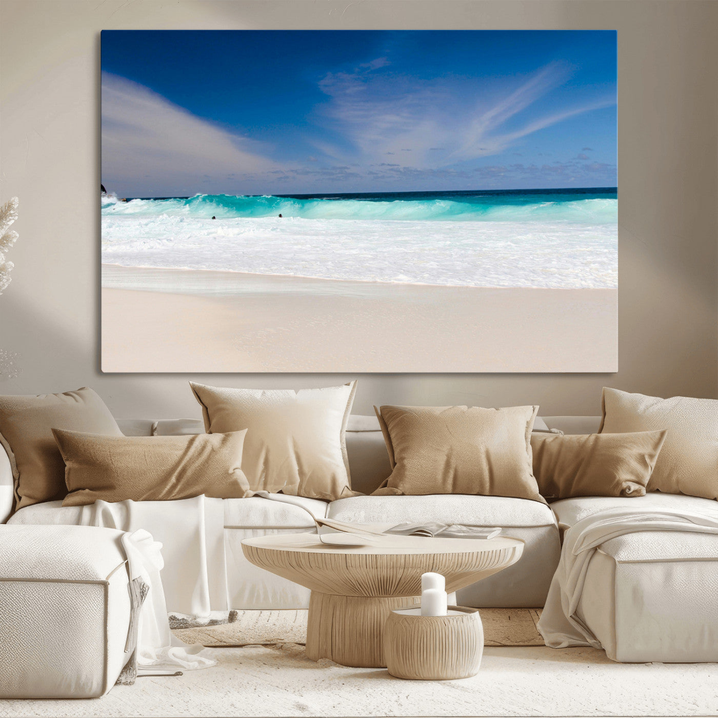 Turquoise waves crash onto a pristine white sand beach under a vivid blue sky with wispy clouds, creating a peaceful and refreshing coastal scene.