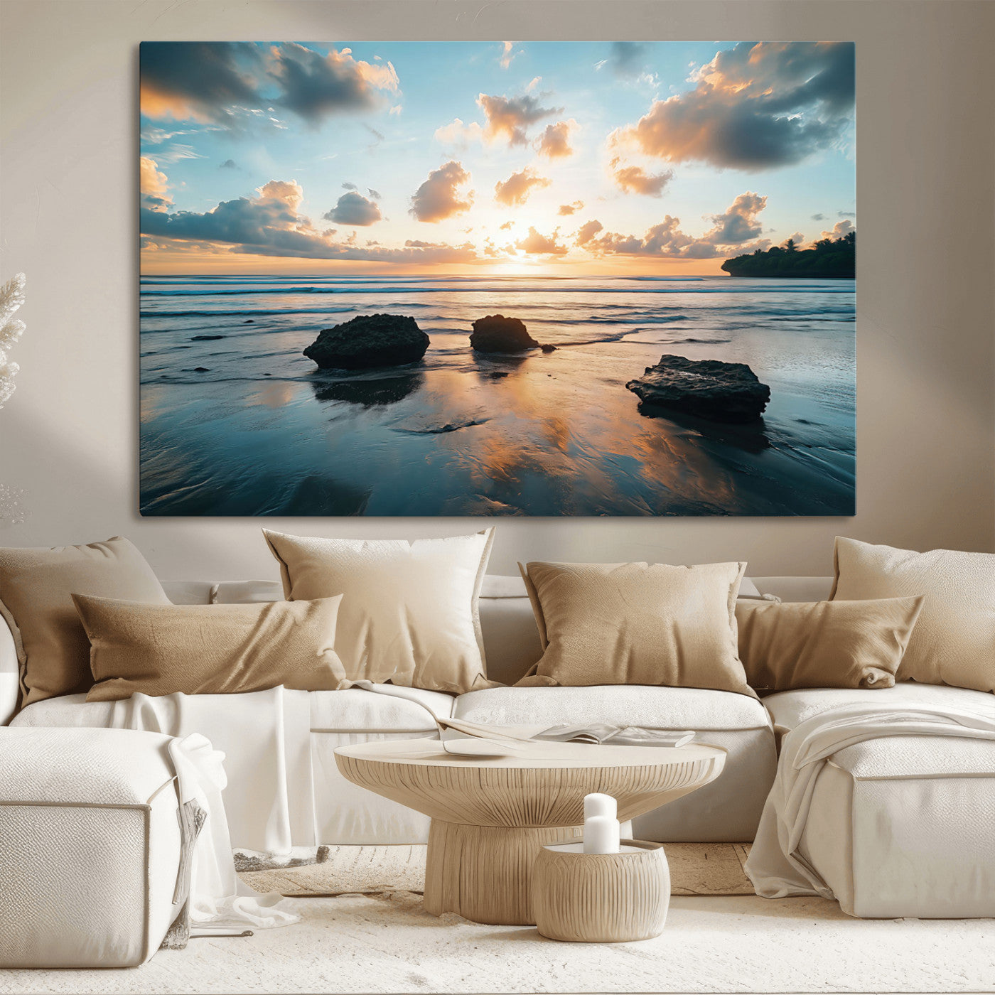 A serene beach at sunset with vibrant clouds, calm water, and rocks in the foreground reflecting the warm colors of the setting sun.