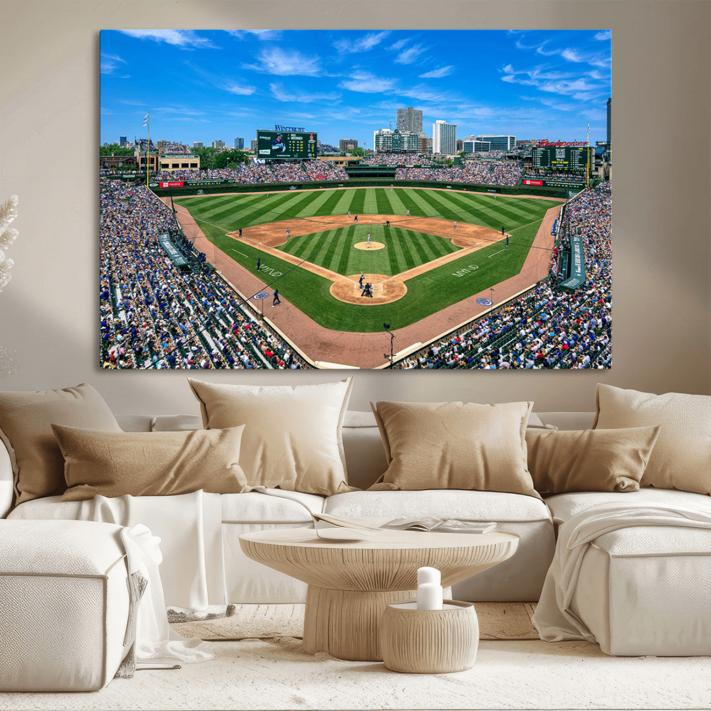 A wide-angle shot of a baseball field filled with spectators, with players on the field and the iconic Wrigley Field scoreboard in the background.