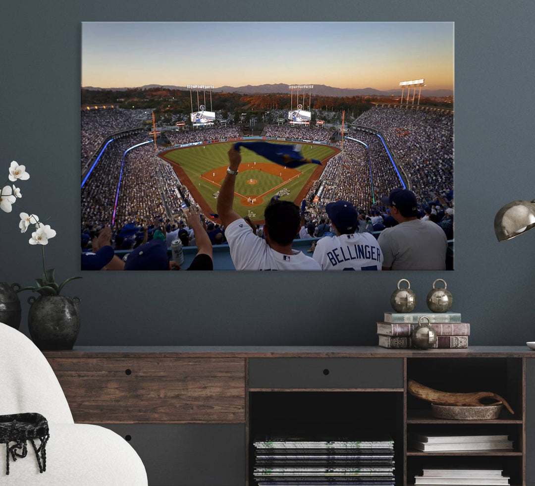 A triple canvas wall art captures the scene at Dodger Stadium, with fans cheering as the sun sets and a flag waving on the field.