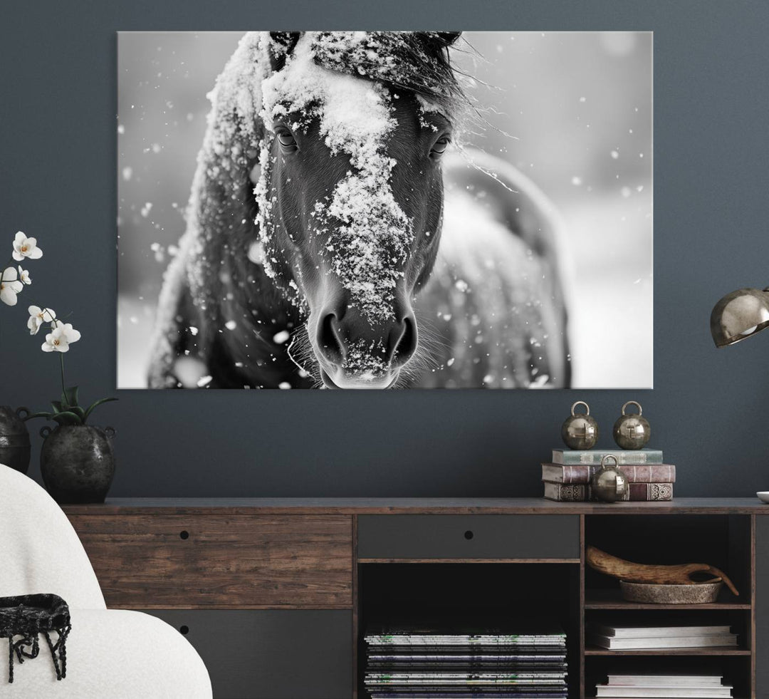 The Black and White Horse Winter Wall Art features a majestic horse with snow-covered hair set against a serene winter backdrop.