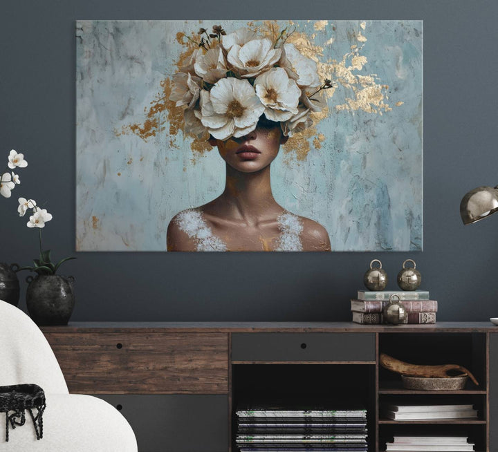 Golden Petal Wall Art: A womans face adorned with a gold floral design on a teal background, presented in a 3-panel modern glam canvas.