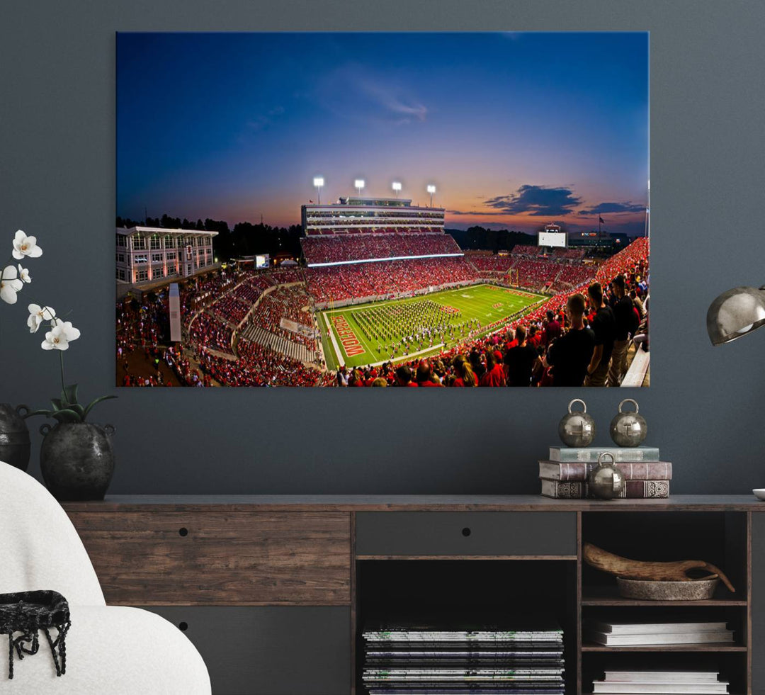 A vibrant and dynamic painting captures the essence of an electrifying night game at Carter-Finley Stadium, highlighting the illuminated atmosphere as the NC State Wolfpack competes under bright stadium lights.