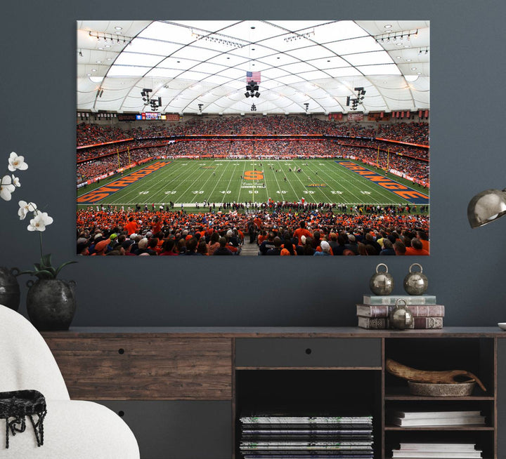 Fans fill the Syracuse JMA Wireless Dome, highlighted in orange and blue under a vaulted roof on this premium canvas print of the scene.