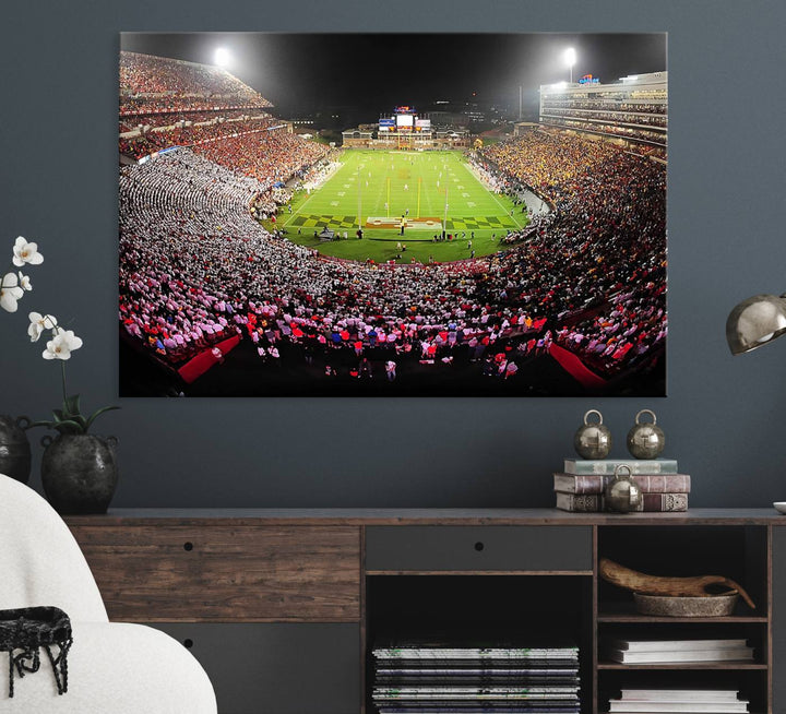 The Maryland Terrapins Football Wall Art Canvas showcases a packed SECU Stadium at night with a bright field and cheering fans.