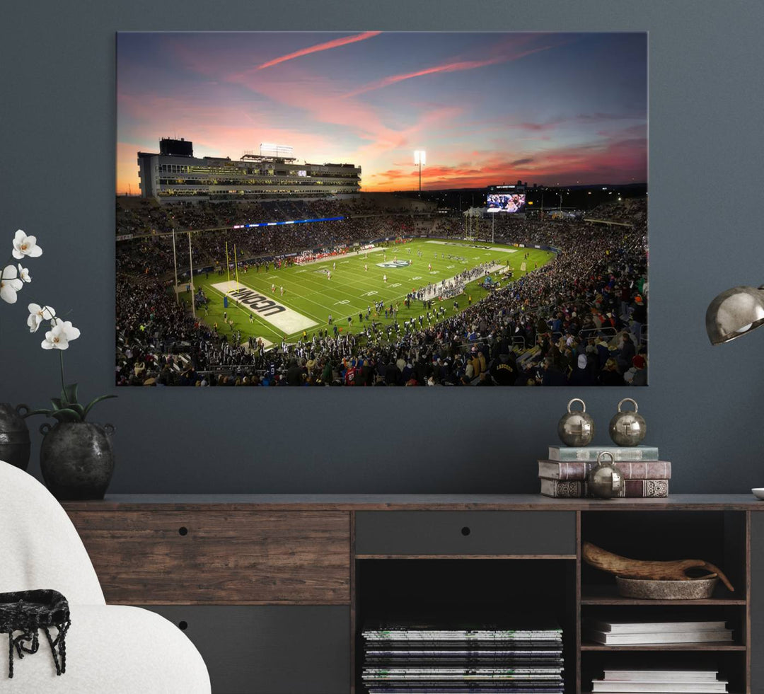 This wall art canvas print captures UCONN Huskies fans energizing a sunset scene at East Hartfords Pratt & Whitney Stadium.