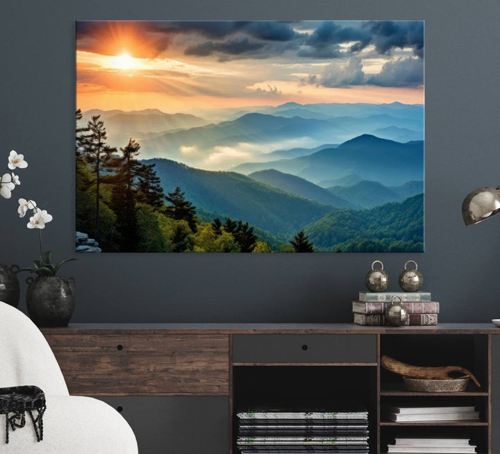 The wall art, titled Sunrise Over Mountain Range, is a canvas print that beautifully depicts layers of hills, scattered trees, and a partly cloudy sky.