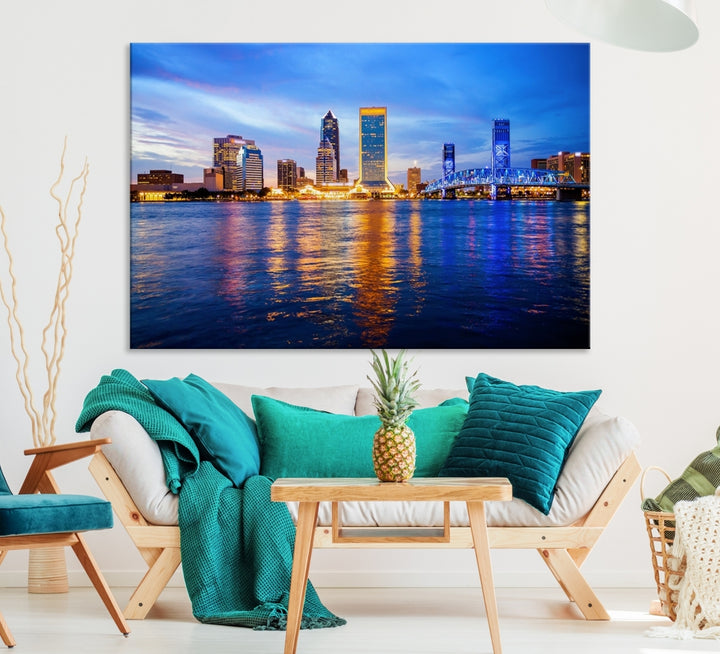 A cozy living room features the Jacksonville Wall Art Canvas Print, a large triptych crafted on museum-quality canvas that beautifully depicts the Jacksonville city skyline at sunset.