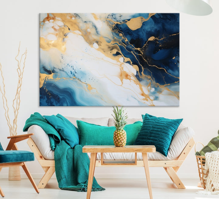 A modern living room featuring museum-quality Blue Gold Abstract Wall Art Print Contemporary art in a triptych arrangement.